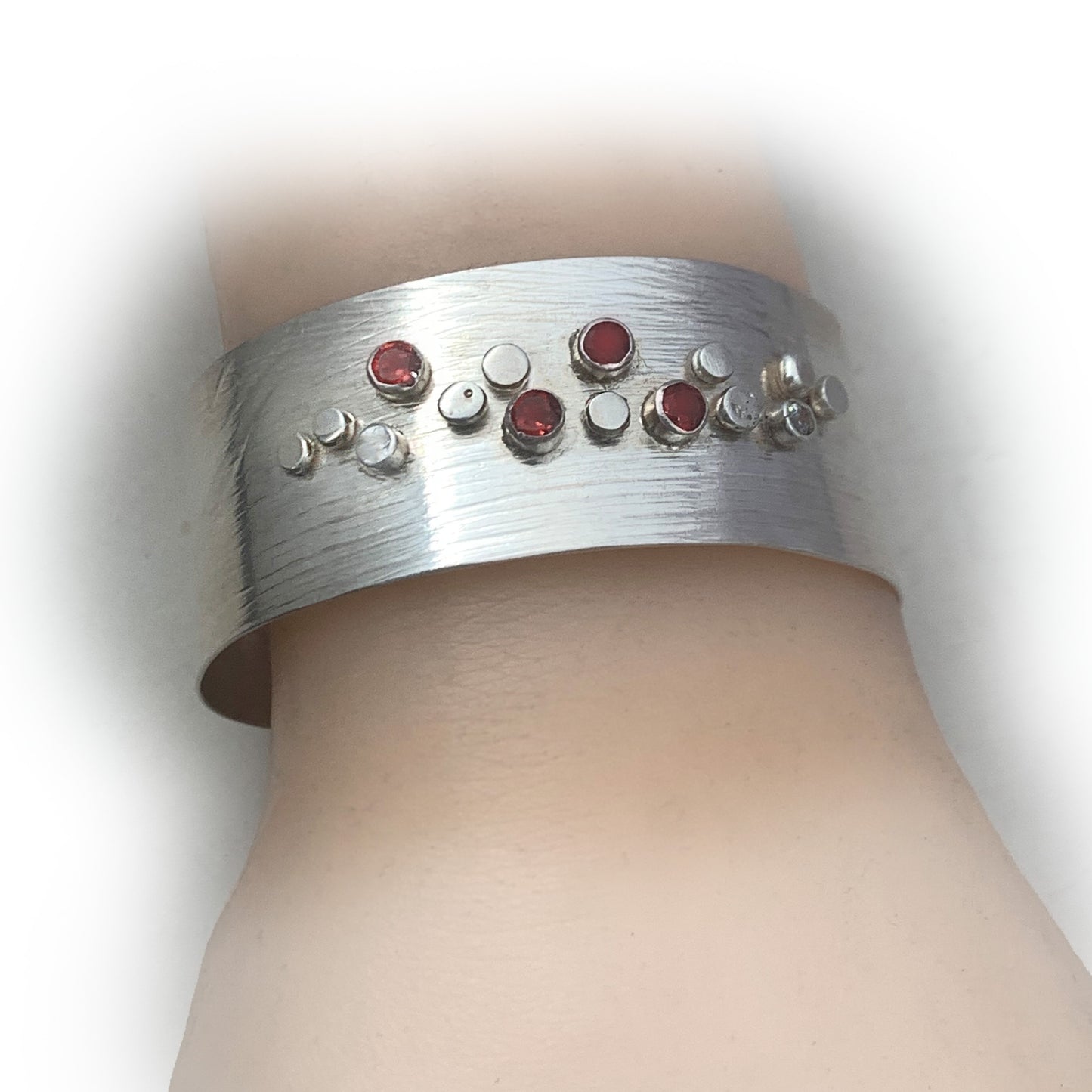 Sterling Silver Galaxy Pattern Cuff with Garnets and Pale Blue Topaz